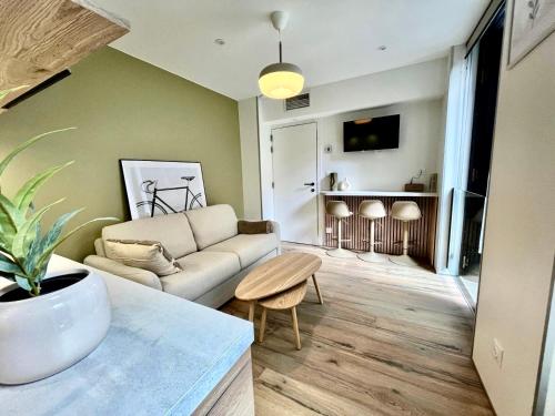 a living room with a couch and a table at LILLEHOSTS 1, Vieux Lille, Newly renovated, Modern & Stylish apartment, perfectly located in Lille