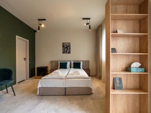 a bedroom with a bed and a book shelf at Craft Inn - Boutique Hotel in Sibiu