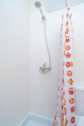a bathroom with a shower curtain with cars on it at Can Joan in Cala Figuera
