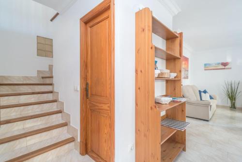 a room with a wooden door and stairs at Can Joan in Cala Figuera