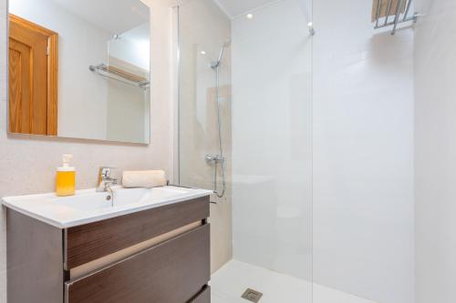 a bathroom with a sink and a shower at Can Joan in Cala Figuera