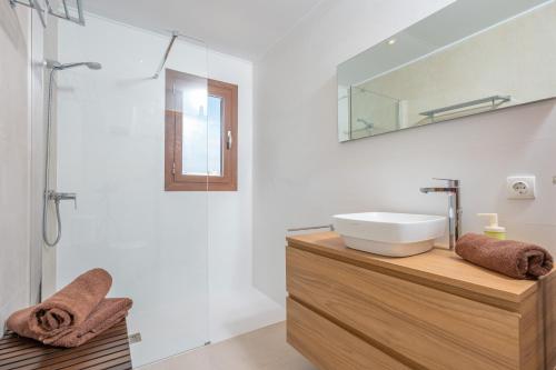 a bathroom with a sink and a mirror at Can Joan in Cala Figuera