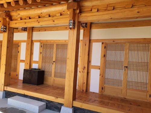 a wooden room with wooden doors and a tv in it at SiEunJae in Gyeongju