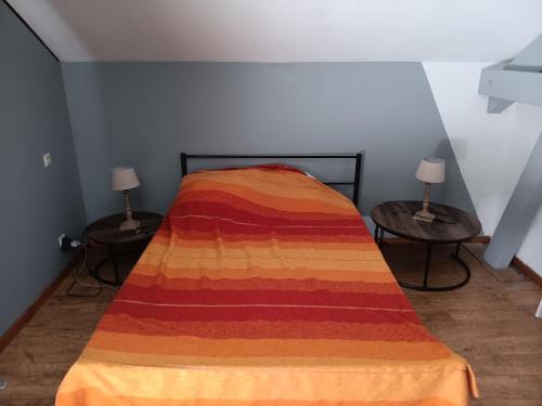 a bedroom with a bed with a colorful blanket on it at Chambre - Sdb Privative - Super Vue in Pallud