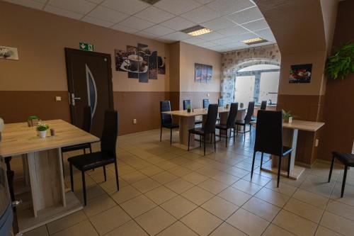 a dining room with wooden tables and chairs at Pension Village in Naumburg