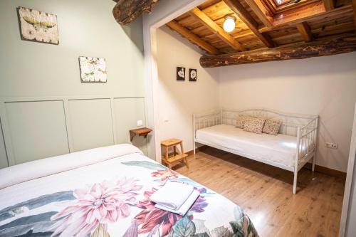 a bedroom with a bed and a bench in a room at Casa Rural La Barquilla in Acebo