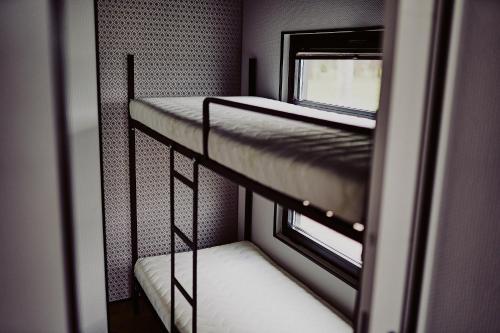 two bunk beds in a room with a window at Houseboats Dollar - Plaża Nowe Guty in Nowe Guty