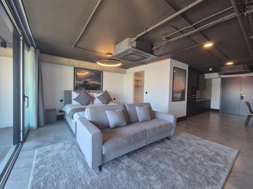a living room with a couch and a bed at The Londoner Hotel Sliema in Sliema