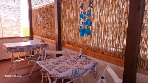 a room with two tables and a table and chairs at Bed and Breakfast La Reale in Stintino