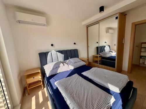 a bedroom with two beds and a mirror at River side 18 in Herceg-Novi