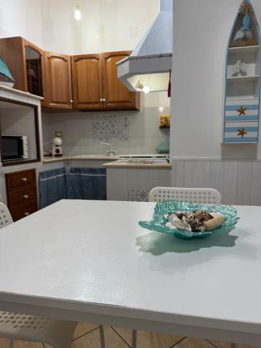 a bowl of food on a white table in a kitchen at Perla Marina in Trappeto