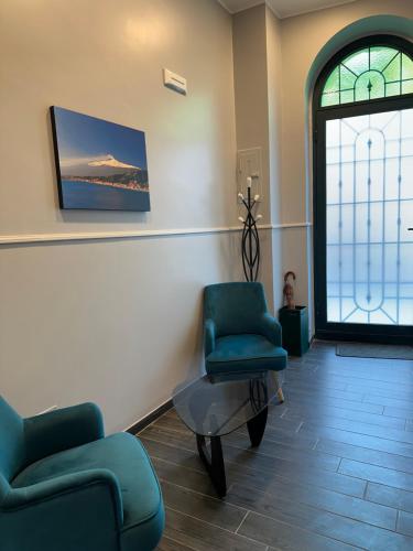 a waiting room with two chairs and a table and a window at Alhambra "Etna Charme" - Guest House in Giarre
