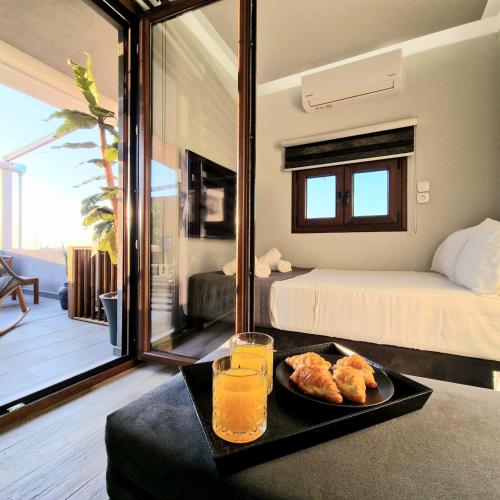 a tray with food and drinks on a table in a room at D&A Luxury suite with private Jacuzzi in Ligaria