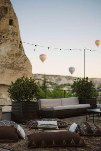 a living room with a couch and some pillows at Carus Cappadocia in Goreme