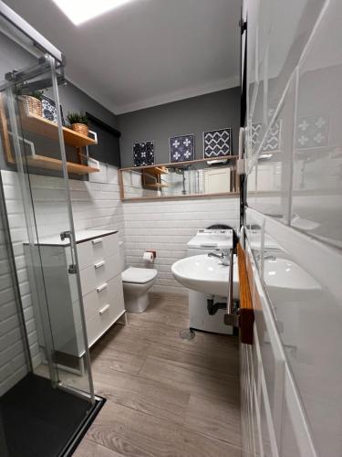 a bathroom with a sink and a toilet at Vivienda Sol in Ferrol