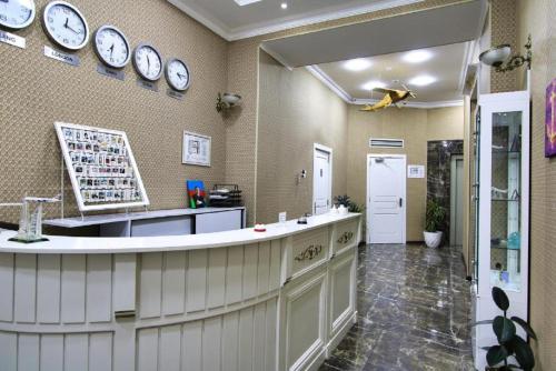 a kitchen with clocks on the wall and a counter at Pilot By Haz Hotel in Baku