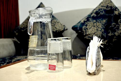 a glass jug of water on a table at Ista Inn Homestay in Amritsar