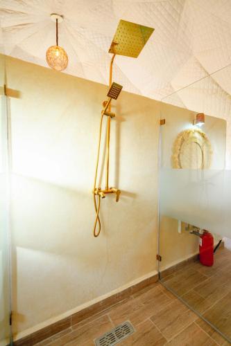a shower in a room with a ceiling at The Orion Dome in El Karia