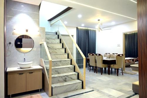 a bathroom with a staircase and a dining room at Ista Inn Homestay in Amritsar