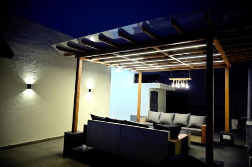 a pergola with couches on a patio at night at Ista Inn Homestay in Amritsar