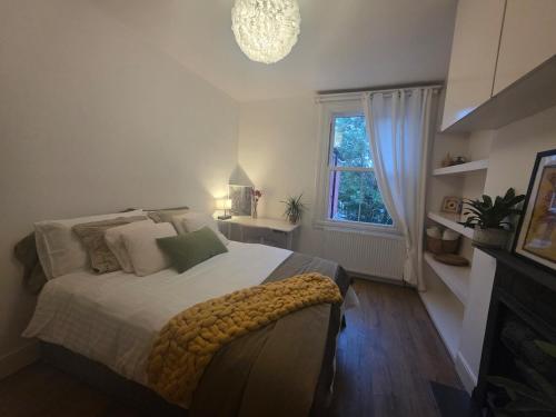 a bedroom with a large bed and a window at Walk to Wembley Stadium and Arena 2 Bedroom Sleeps 4 in London