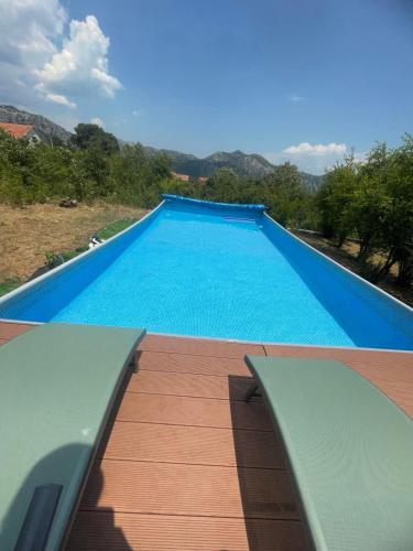 a large blue swimming pool on top of a house at Bed & Wine Djonovic in Virpazar
