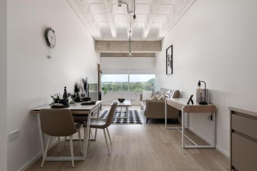 a dining room and living room with a table and chairs at Black and White Suite for Business and Holiday stays above MK Train Station, High Wi-Fi, Free Parking in Milton Keynes