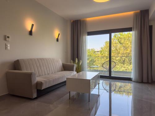 a living room with a couch and a table at VILLA 8 By ProLiving Hospitality in Thessaloniki