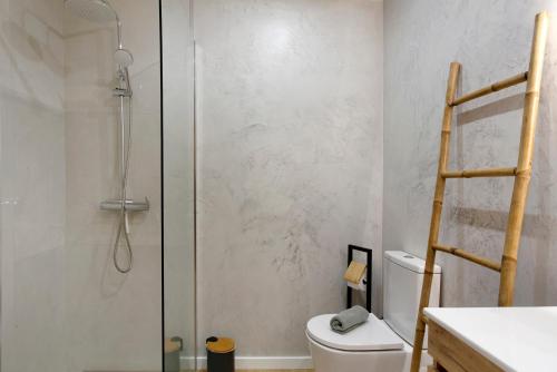 a bathroom with a shower with a toilet and a sink at Ti Clara View Apartment in Caniço