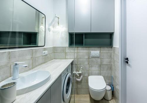 a bathroom with a white sink and a toilet at Bamboo Beach Tsikhisdziri Green Heaven in Tsikhisdziri
