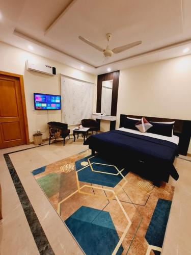 a bedroom with a bed and a flat screen tv at Dream Lodge House in Islamabad