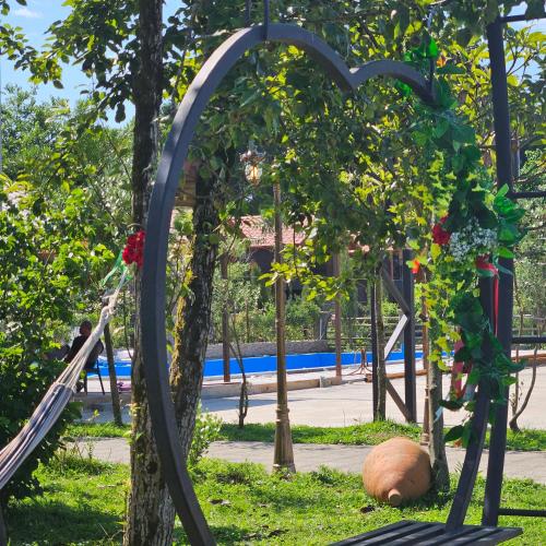 an arch in a park with a playground at Iveria Parky and cottages in Shekvetili