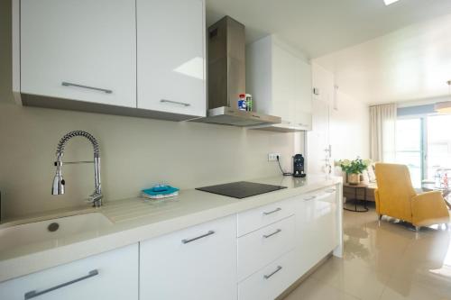 a kitchen with white cabinets and a sink at Mirador del Mar in Torrevieja
