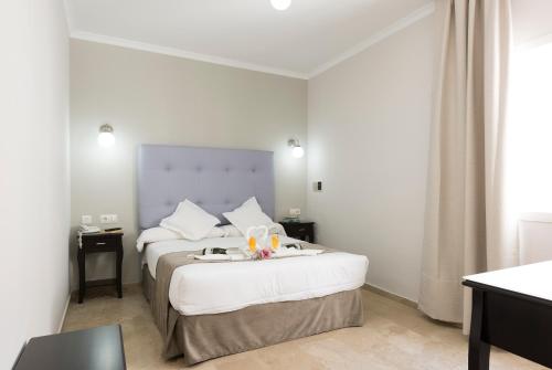 Cama o camas de una habitación en Hotel Toboso Chaparil
