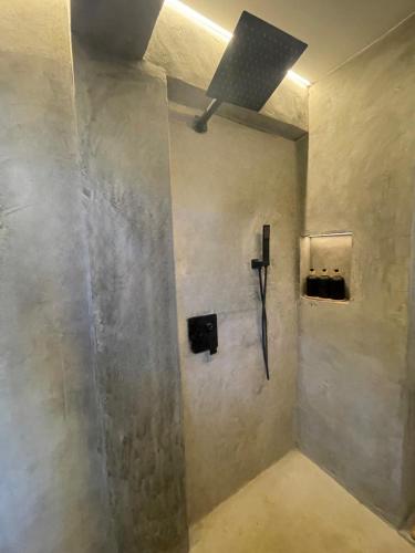 a bathroom with a wall with a light on it at Drako Villas in Siquijor