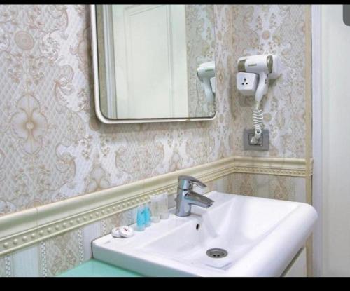 a bathroom with a sink and a mirror at Pilot By Haz Hotel in Baku