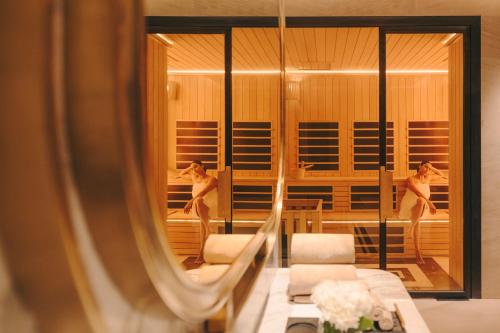 a reflection of a woman in a mirror at Fairmont Mumbai in Mumbai