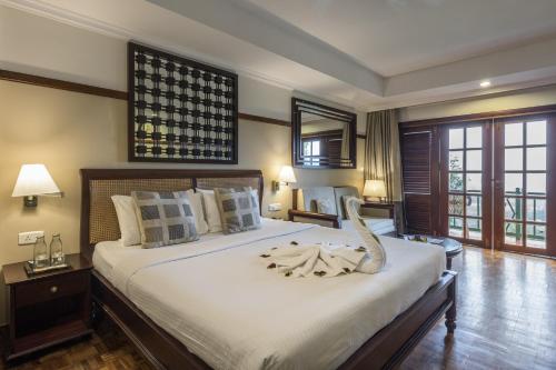 a bedroom with a large bed with a snake on it at Club Mahindra Lake View Munnar in Chinnakanal