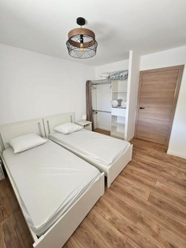 a bedroom with two beds and a closet at appartement le blanco neige in Puyvalador