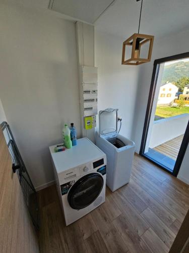a laundry room with a washing machine and a dryer at appartement le blanco neige in Puyvalador