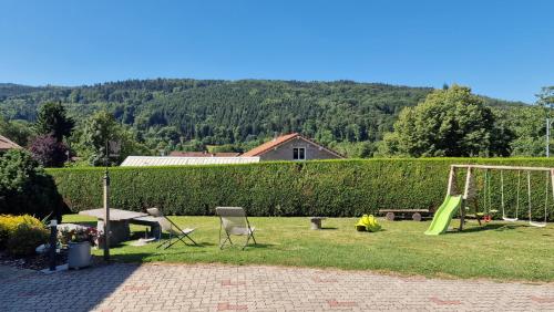 a backyard with a swing set and a playground at Le Domaine de la Répandise in Laveline-du-Houx