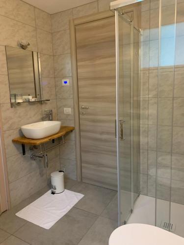 a bathroom with a sink and a shower at La Casetta in Morbegno