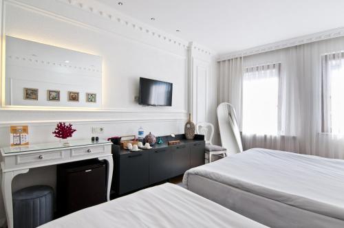 a hotel room with two beds and a fireplace at Sadaret Hotel-Old City Sultanahmet in Istanbul