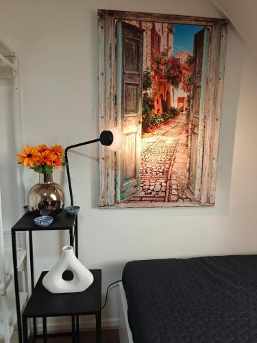 a bedroom with a bed and a painting on the wall at Eastern in Tilburg