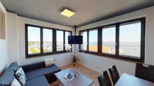 a living room with a couch and some windows at Haus 1 in Niederdorla