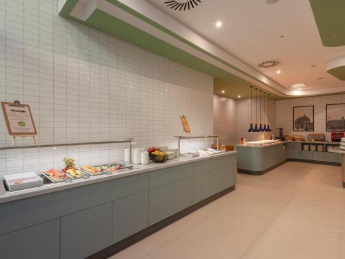 a restaurant with a buffet line with food at Hampton By Hilton Dresden City Centre in Dresden
