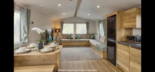 a living room with a couch and a table at Morsh Luxury Caravan Getaway in Colchester