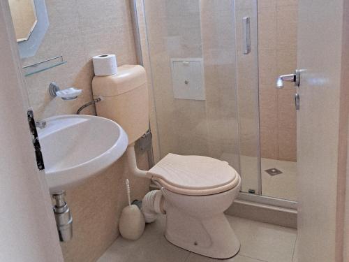 a bathroom with a toilet and a sink at Guest House Paskal in Sunny Beach