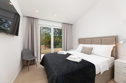 a bedroom with a large bed and a window at Villa Hidden with heated pool in Dobrinj
