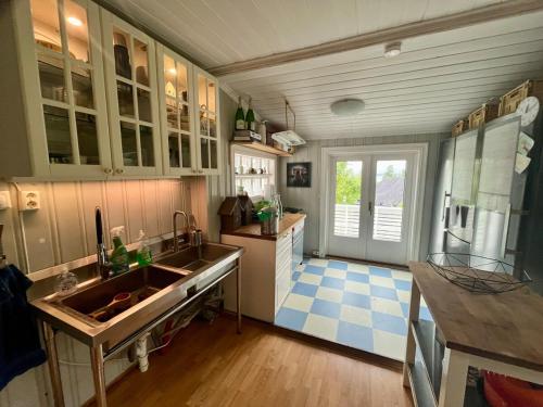 a kitchen with a sink and a blue and white tile floor at Close to Oslo and the beach 